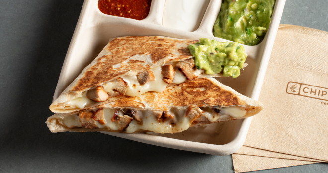 A Chicken Quesadilla from Chipotle with a side of fresh made Guac, Sour Cream, and Tomatilla-Red Chili Salsa.